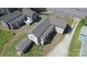 Aerial view showcasing the home's layout, surrounding yard, and outbuilding at 921 W 1St St, Lowell, NC 28098