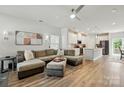 Spacious open-concept living room with a large sectional, hardwood floors, and a view of the kitchen at 1015 Maltby St, Charlotte, NC 28217