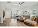 Bright and airy living room featuring a comfortable sectional, a ceiling fan, and a functional workspace at 1015 Maltby St, Charlotte, NC 28217