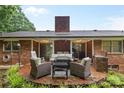 Cozy brick outdoor patio complete with comfortable seating and brick fireplace perfect for entertaining at 1081 Long Dr, Newton, NC 28658