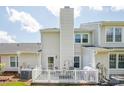 Outdoor patio with a grill and seating area overlooking the yard at 10945 Winterbourne Ct, Charlotte, NC 28277