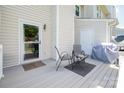 Cozy outdoor patio featuring a grill, seating, and a serene backyard view at 10945 Winterbourne Ct, Charlotte, NC 28277