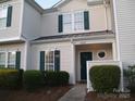 Attractive two-story townhome featuring a well-manicured lawn and a covered entryway at 11107 Lions Mane St, Charlotte, NC 28273