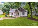 Charming single-story home with a lovely front yard, porch, and traditional design elements at 124 Cedarcroft Dr, Mooresville, NC 28115