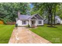 Exterior front view of single-story home featuring a well-kept lawn and driveway at 124 Cedarcroft Dr, Mooresville, NC 28115