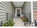 Inviting front porch features a cozy bench, potted plants, and a welcoming entrance with stylish decor at 12637 Belmont Mansion Dr, Charlotte, NC 28273