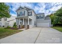 Charming two-story home with a welcoming front porch and a spacious two-car garage at 12719 Walking Stick Dr, Charlotte, NC 28278