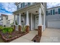 Inviting front porch featuring classic columns, decorative brick accents, and a 'Welcome' sign at 12719 Walking Stick Dr, Charlotte, NC 28278