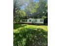 Quaint single-story home with brick foundation and front stairs surrounded by mature trees and greenery at 151 First S St # 122 & 123, Fort Mill, SC 29708