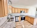 Open kitchen with stainless steel appliances, wood cabinets, and granite countertops at 1657 Diary Dr, Rock Hill, SC 29730