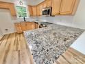 Bright kitchen with stainless steel appliances, granite countertops, and wood floors at 1657 Diary Dr, Rock Hill, SC 29730