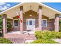 Inviting brick front entrance with a covered porch and decorative flag at 2078 Valley View Ln, Lincolnton, NC 28092