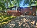 Rear exterior view of a single-story home with a lattice-skirted porch and a small yard at 2461 Ridgecrest Dr, Stanley, NC 28164