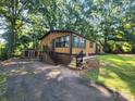 Exterior view of a house with a brown exterior, green shutters, and a small storage shed at 2461 Ridgecrest Dr, Stanley, NC 28164