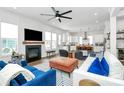 Spacious living room with fireplace, large windows, and open layout to kitchen and bar for seamless entertaining at 2600 Palm Ave, Charlotte, NC 28205