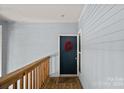 Charming front door adorned with a festive wreath, complemented by light blue siding at 2625 E 5Th St # F, Charlotte, NC 28204
