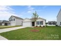 Well-maintained home featuring an attached garage and a neatly landscaped front yard with green grass at 2656 Goose Fair Rd # 126, Maiden, NC 28650