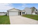 Charming home with a spacious driveway and attached garage, complemented by lush green grass and attractive landscaping at 2656 Goose Fair Rd # 126, Maiden, NC 28650
