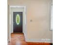 Entryway with hardwood floors leading to an oval glass paneled front door and white walls at 2722 Catawba Church Rd, Rock Hill, SC 29730