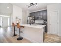 Modern kitchen featuring sleek countertops with barstool seating, stainless steel appliances, and ample cabinet space at 2836 Rosemeade Dr, Monroe, NC 28110