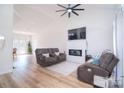 Bright living room featuring hardwood floors, a cozy fireplace, and comfortable seating, perfect for relaxation at 2836 Rosemeade Dr, Monroe, NC 28110