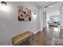Foyer with hardwood floors, a bench, and decorative artwork on the wall at 3255 Split Rail Ln, Lancaster, SC 29720