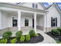 Inviting front porch features decorative pillars and manicured landscaping at 3255 Split Rail Ln, Lancaster, SC 29720