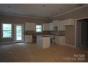 Unfinished kitchen with white cabinets, granite countertops, and a center island; ready for personalization at 3452 Hands Mill Hwy, York, SC 29745