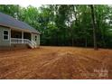 Side exterior of home showing spacious yard with mature trees at 3452 Hands Mill Hwy, York, SC 29745