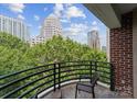 Beautiful city views from this brick balcony with black metal railings, perfect for relaxing outdoors at 400 N Church St # 422, Charlotte, NC 28202