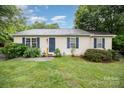 Charming single-story home with a well-maintained lawn and inviting front entrance, offering great curb appeal at 401 Yadkin St, Granite Quarry, NC 28072