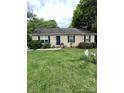 Inviting home with a well-maintained lawn, beautiful landscaping, and charming curb appeal at 401 Yadkin St, Granite Quarry, NC 28072
