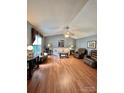Spacious living room with wood flooring, a ceiling fan, and comfortable seating at 401 Yadkin St, Granite Quarry, NC 28072