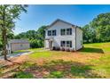Side view of two-story home, green lawn, and bright blue sky at 415 Kickapoo Ave, Gastonia, NC 28056