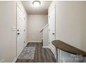 Inviting hallway with neutral walls, dark wood-look floors, and white trim at 415 Kickapoo Ave, Gastonia, NC 28056