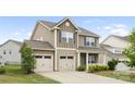 Attractive home featuring a two-car garage, classic architecture, and manicured landscaping at 5160 Thomasville Dr # 123, Belmont, NC 28012