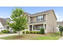 Inviting two-story home featuring manicured landscaping and a charming covered front porch at 5160 Thomasville Dr # 123, Belmont, NC 28012