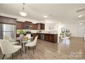Open eat-in kitchen featuring stainless steel appliances, dark wood cabinets, and hardwood flooring at 5160 Thomasville Dr # 123, Belmont, NC 28012