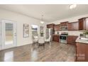 Eat-in kitchen features stainless steel appliances, dark wood cabinetry, and hardwood flooring at 5160 Thomasville Dr # 123, Belmont, NC 28012