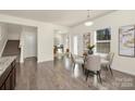 Open eat-in kitchen and living space features hardwood floors, plenty of light, and neutral decor at 5160 Thomasville Dr # 123, Belmont, NC 28012