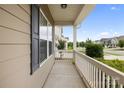 Relaxing outdoor porch area with charming white railings and neighborhood views at 5160 Thomasville Dr # 123, Belmont, NC 28012