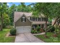 Two-story home with attached two-car garage, well-maintained landscaping and a welcoming front porch at 5233 Fairvista Dr, Charlotte, NC 28269