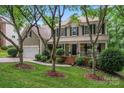 Two-story home with a covered front porch, black shutters and an attached two-car garage at 5233 Fairvista Dr, Charlotte, NC 28269