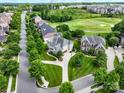 Aerial view of a neighborhood featuring manicured lawns, mature trees, and golf course access at 538 Fairwoods Dr, Huntersville, NC 28078