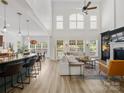 Open-concept living room with high ceilings, many windows, hardwood floors, and comfortable seating at 538 Fairwoods Dr, Huntersville, NC 28078