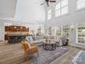 Spacious living room with high ceilings, open layout, modern lighting, and views to the kitchen and dining areas at 538 Fairwoods Dr, Huntersville, NC 28078