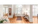 Bright foyer with hardwood floors, grand entrance, stylish decor, and elegant front door at 7018 Dowington Dr, Charlotte, NC 28277