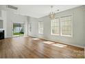 Spacious living room with abundant natural light, wood floors, and a sliding glass door to the backyard at 8605 Sawleaf Ct, Charlotte, NC 28215