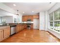Open kitchen featuring stainless steel appliances, wood cabinets, and hardwood flooring at 939 White Point Dr, Huntersville, NC 28078