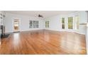 Bright living room with hardwood floors, large windows and glass paneled door to outdoors at 939 White Point Dr, Huntersville, NC 28078